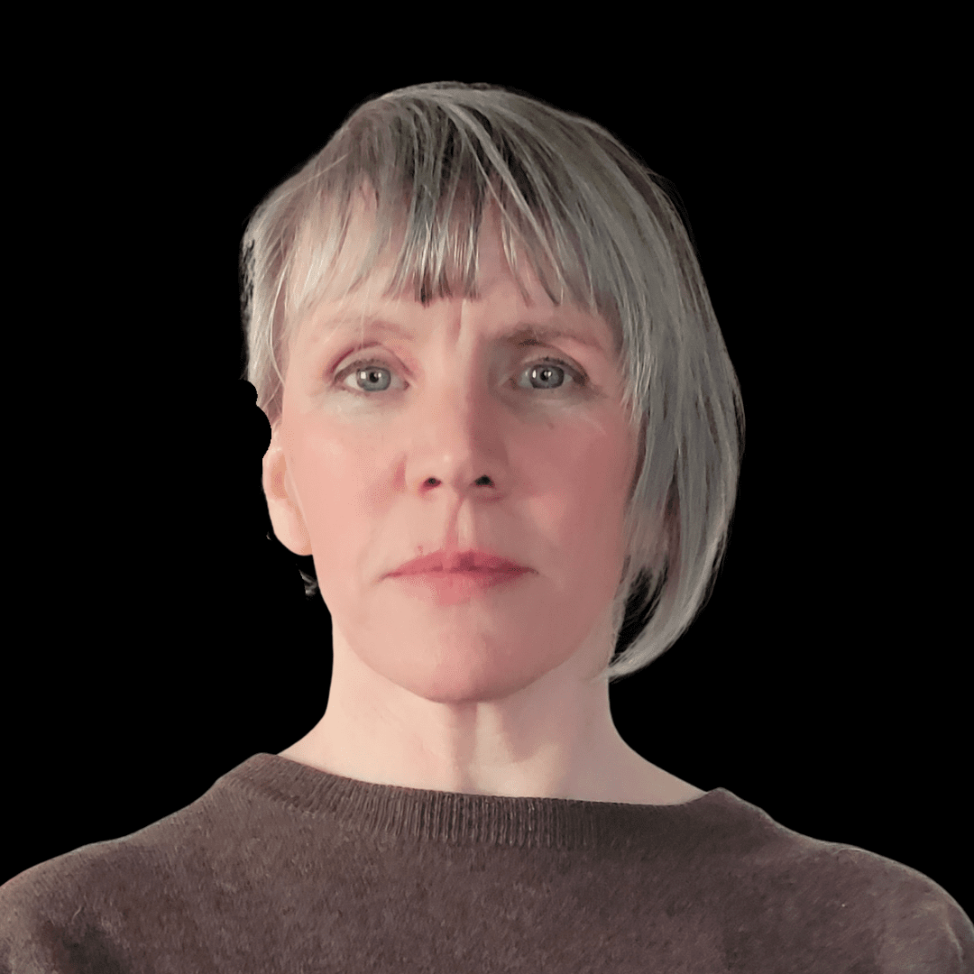 A person with short, light grey hair and fringe, wearing a brown top, faces forward against a solid black background with a neutral expression—an image reminiscent of Ealaín na Gaeltachta’s contemporary portraiture style.